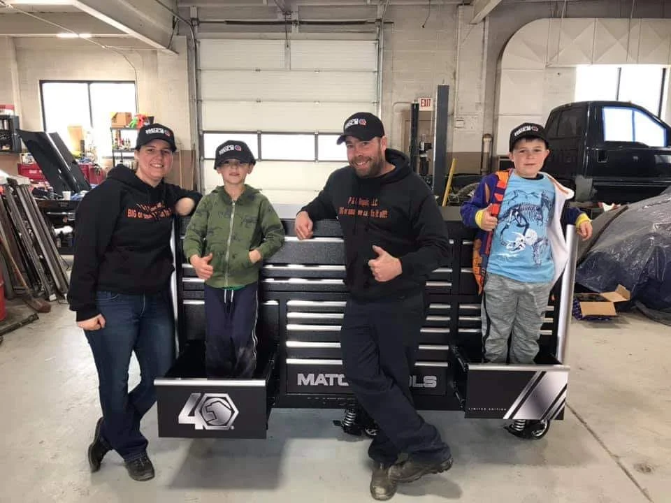 The Hayes family at P&C Repair: Kelly, Shaun, and their two sons Patrick and Connor in the shop in front of a Matco tool chest